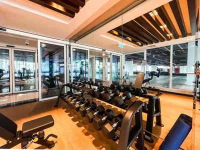 a gym with treadmills and elliptical machines at Gemz by Danube with Private Pool - Onelink in Dubai