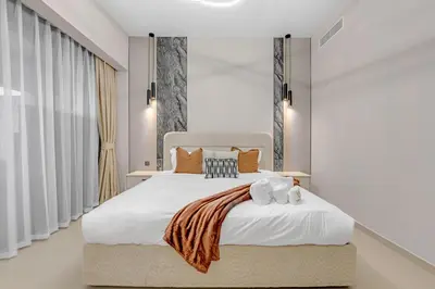 a bedroom with a white bed with two stuffed animals on it at Full Burj Khalifa 3BR in Act Towers in Dubai