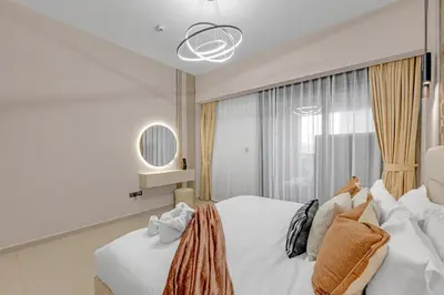 a bedroom with a white bed and a window at Full Burj Khalifa 3BR in Act Towers in Dubai