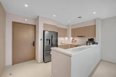a kitchen with a stainless steel refrigerator and cabinets at Full Burj Khalifa 3BR in Act Towers in Dubai