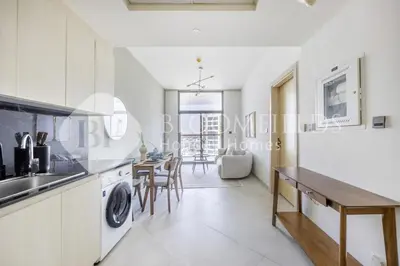 a kitchen and dining room with a sink and a table at 202-Bloomfields Iconic 1br Binghatti Avenue in Dubai