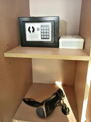 a microwave sitting on top of a shelf with a microphone at Bright Apartment in JVC with Pool in Dubai
