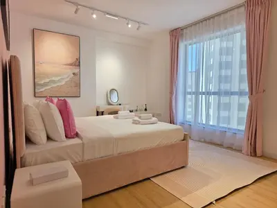 a bedroom with a large bed and a large window at Spacious 2BR Apartment Rimal 1 JBR EB in Dubai
