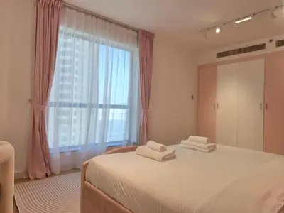 a bedroom with a bed with two towels on it at Spacious 2BR Apartment Rimal 1 JBR EB in Dubai