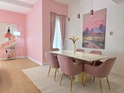 a dining room with pink walls and a table and chairs at Spacious 2BR Apartment Rimal 1 JBR EB in Dubai