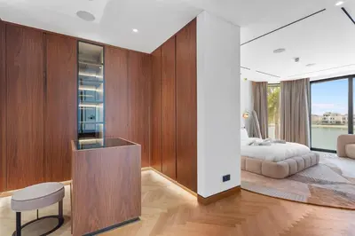 a bedroom with a bed and a table and a chair at Premium 4 BR Villa in Palm Jumeirah with Private Pool in Dubai