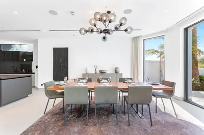 a dining room with a table and chairs at Premium 4 BR Villa in Palm Jumeirah with Private Pool in Dubai