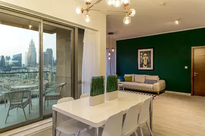 a living room with a table and a couch at La Dolce Vita in Dubai