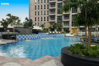 a swimming pool in front of a tall building at bnbmehomes - Stand Point Tower A in Dubai