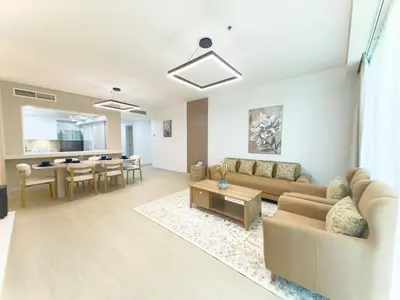a living room with a couch and a table at Classy 2BR Dubai Getaway with Sea view in JBR in Dubai