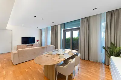 a living room with a table and a couch at Bluewaters Residences 1BR Prime Sea and Ain View in Dubai