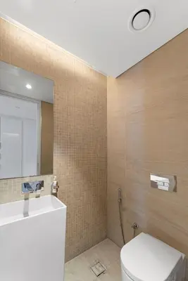a bathroom with a white toilet and a mirror at Bluewaters Residences 1BR Prime Sea and Ain View in Dubai
