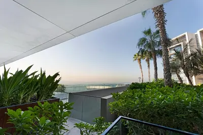 an external view of a building with palm trees at Bluewaters Residences 1BR Prime Sea and Ain View in Dubai
