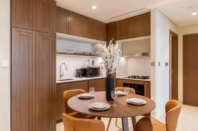 a kitchen and dining room with a table and chairs at Chic 1BR Sea View, Palace Beach Residence in Dubai