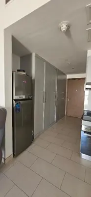 a kitchen with stainless steel refrigerator and cabinets at Peace Home in Dubai
