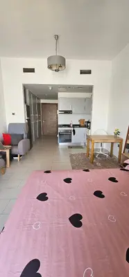 a living room with a pink rug on the floor at Peace Home in Dubai