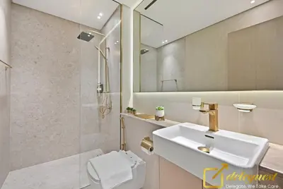 a bathroom with a sink and a toilet and a shower at Bright 1BR Apartment in Binghatti Phoenix High-Floor Views in Dubai
