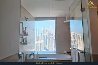 a bathroom with a shower with a view of a city at Deluxe 5 stars Suite - JW Marriott-Marina Mall - Once you see it, you book it! in Dubai