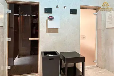 a door to a shower with a stool next to it at Deluxe 5 stars Suite - JW Marriott-Marina Mall - Once you see it, you book it! in Dubai