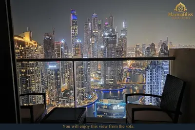 a view of a city skyline at night from a window at Deluxe 5 stars Suite - JW Marriott-Marina Mall - Once you see it, you book it! in Dubai