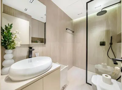a bathroom with a white sink and a shower at Oceanview Palmview Dubai Eye Ain Marina 2BHK in Dubai