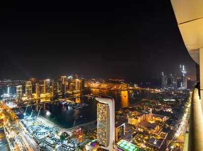 a view of a city at night at Oceanview Palmview Dubai Eye Ain Marina 2BHK in Dubai