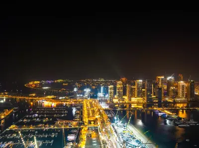 a city lit up at night with buildings at Oceanview Palmview Dubai Eye Ain Marina 2BHK in Dubai