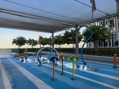 a pool with a water park with colorful water slides at 18 Vida Dubai Mall Newly Furnished 1 bedroom in Dubai