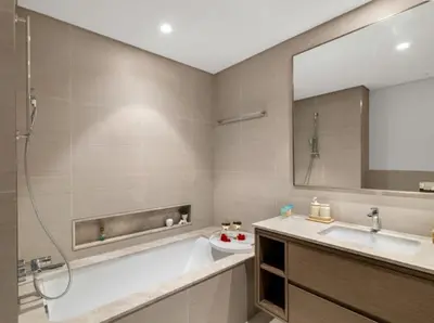a bathroom with a tub and a sink and a mirror at Ultra-luxury 2BHK apartment Stunning Burj Khalifa & Fountain view in Dubai