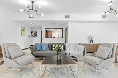 a living room with a couch and two chairs and a table at VayK - Spacious 3BR in JBR with Beach Access in Dubai
