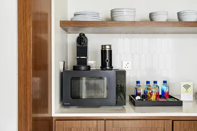 a microwave on a shelf in a kitchen at Luxury Branded Suite with Direct Private Beach Access & Sea Views in Dubai