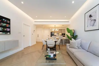 a living room with a couch and a table at Upgraded Serene 1BR Retreat in The Greens in Dubai