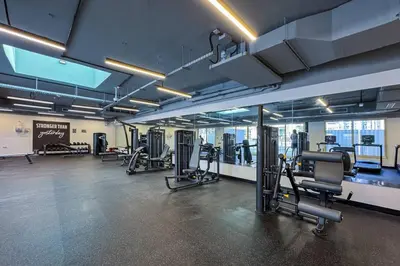 a gym with several treadmills and exercise equipment at Upgraded Serene 1BR Retreat in The Greens in Dubai