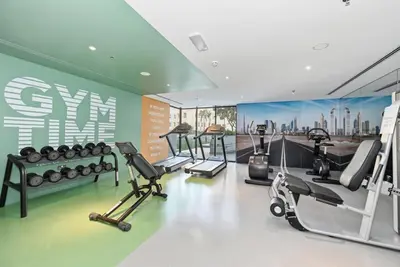 a gym with treadmills and elliptical machines at Dubai JVC - Oxford Residence 2 - Parking&Balcony in Dubai