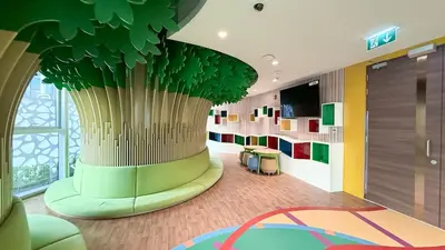 a lobby with a large tree in the middle of a room at 3BR with Burj Khalifa View - Pool - Gym - Downtown in Dubai