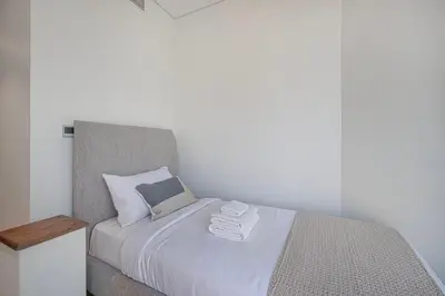 a bedroom with a bed with two towels on it at 3BR with Burj Khalifa View - Pool - Gym - Downtown in Dubai
