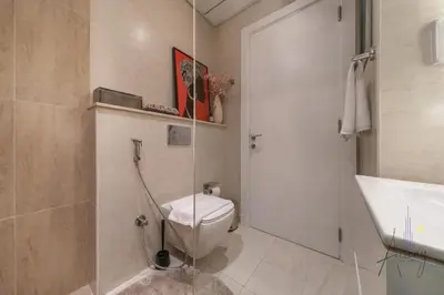 a bathroom with a toilet and a shower and a sink at Skyline View Stu 20th Floor Regina Tower, JVC in Dubai
