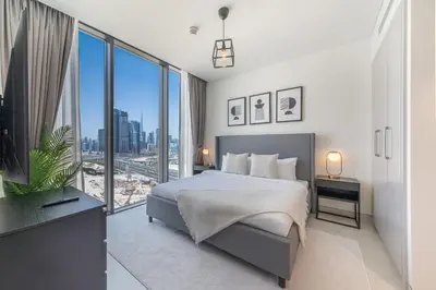 a bedroom with a bed and a large window at Creek Vista Elegance-1BRBurj Khalifa View in Dubai