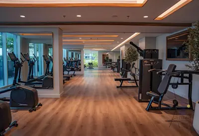 a gym with treadmills and elliptical machines at Elite Beachfront Living Stylish High-Floor 1BR in Dubai