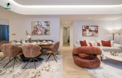 a living room with a table and a couch at Modern Marina-View 3 BR Prime Waterfront in Dubai