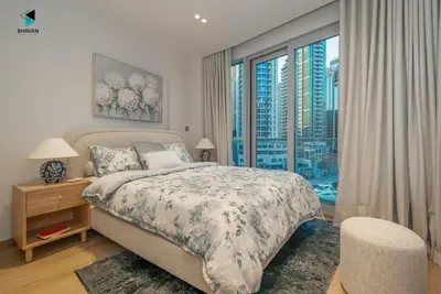 a bedroom with a bed with a view of a city at Modern Marina-View 3 BR Prime Waterfront in Dubai