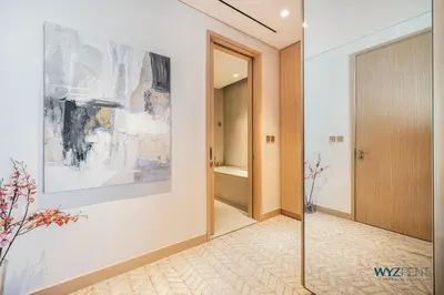 a hallway with a large painting on the wall at Ritz 1BR Vida Dubai Mall Hotel Amenity & Mall Access in Dubai