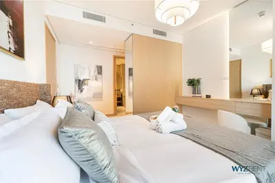 a bedroom with a large white bed with pillows at Ritz 1BR Vida Dubai Mall Hotel Amenity & Mall Access in Dubai