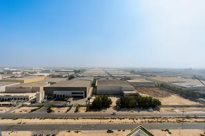 an aerial view of a large industrial building at Cozy 1BR Apartment, 20 Min to Jebel Ali Beach in Dubai