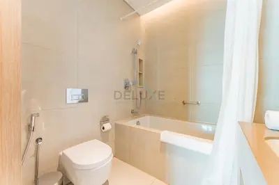 a bathroom with a toilet and a tub and a sink at Direct Beachfront Access, Connected to Address Beach Resort, Unmatched Walkability Near Cafes, Restaurants and Retail shops - Jumeirah Gate Tower, JBR by Deluxe Holiday Homes in Dubai
