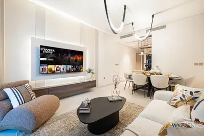 a living room with a couch and a tv at Posh 2BR Vida Dubai Mall Hotel Amenity & Mall Access in Dubai