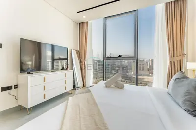a bedroom with a large white bed with a large window at Minutes from City Walk, Downtown Dubai and Jumeirah Beach, Easy Access to Metro Stations and Major Roads - Arista One, Al Satwa by Deluxe Holiday Homes in Dubai