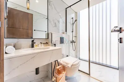 a white bathroom with a sink and a toilet at Minutes from City Walk, Downtown Dubai and Jumeirah Beach, Easy Access to Metro Stations and Major Roads - Arista One, Al Satwa by Deluxe Holiday Homes in Dubai