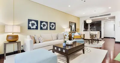 a living room with a couch and a table at 1BR Apartment Anantara Palm Private Beach in Dubai