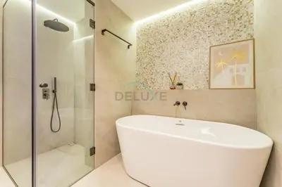 a bathroom with a white tub and a shower at Full Yacht Harbour and Marina Canal Views, Walking Distance to Tram Station and Beach - Shemara W2, Dubai Marina by Deluxe Holiday Homes in Dubai